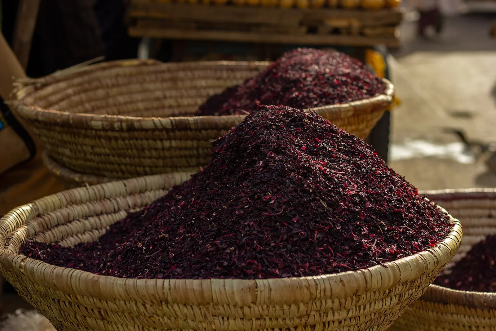 Baskets of dried hibiscus flowers at a market