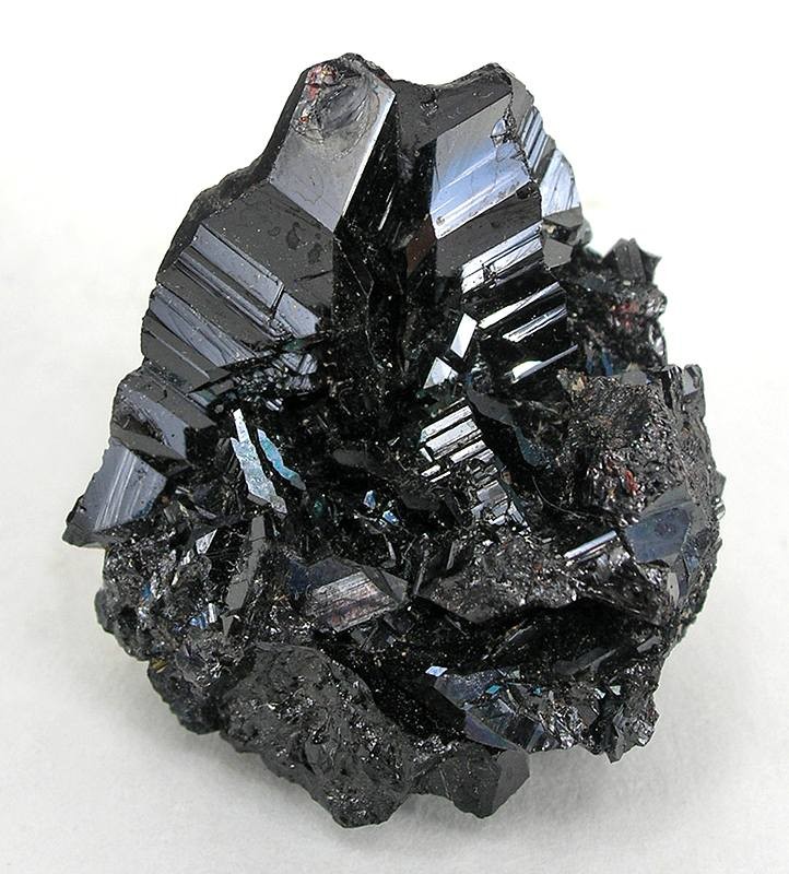 A cassiterite mineral specimen shown as a tin-ore reference