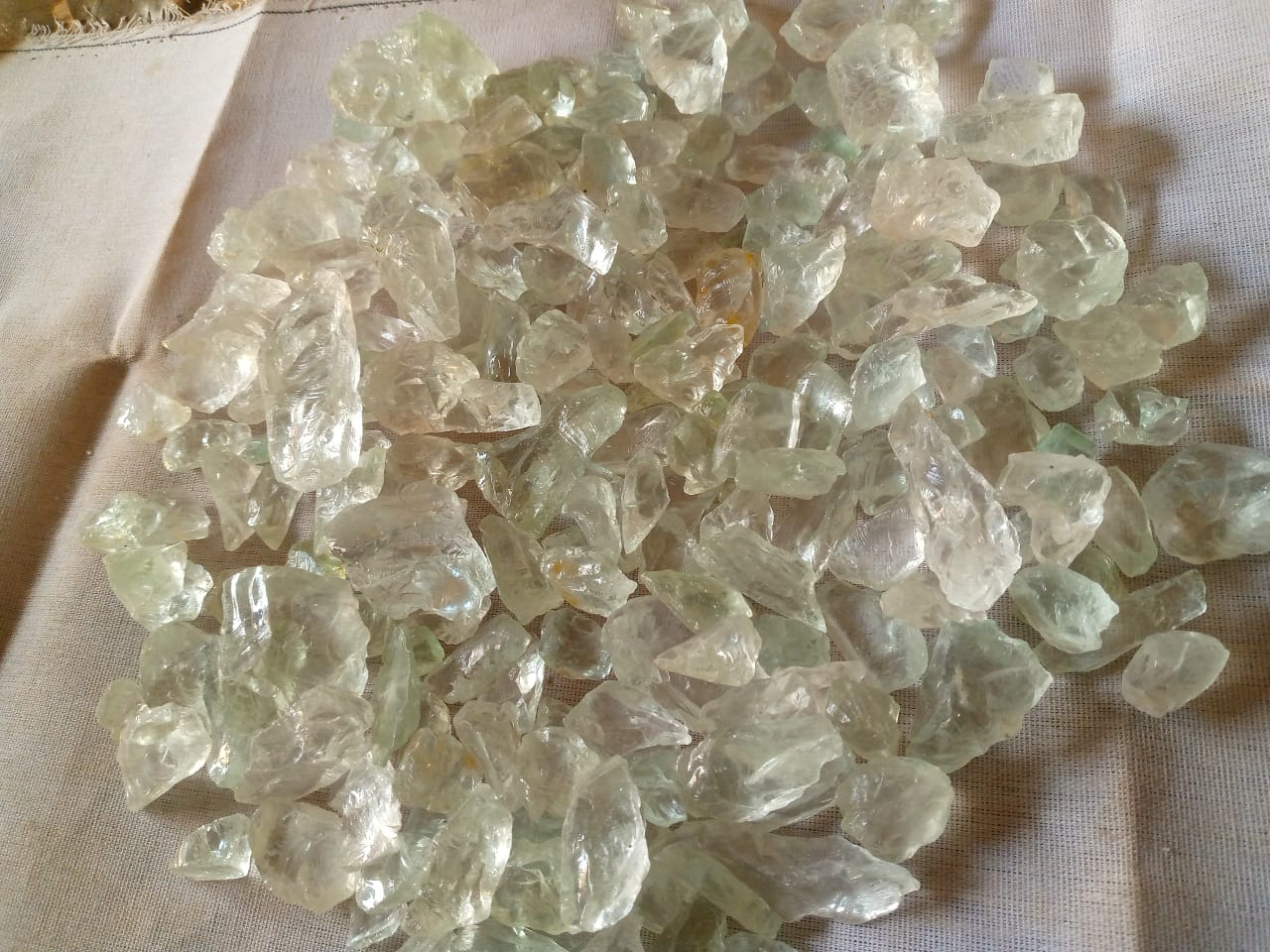 Violet rough stones displayed on a light fabric