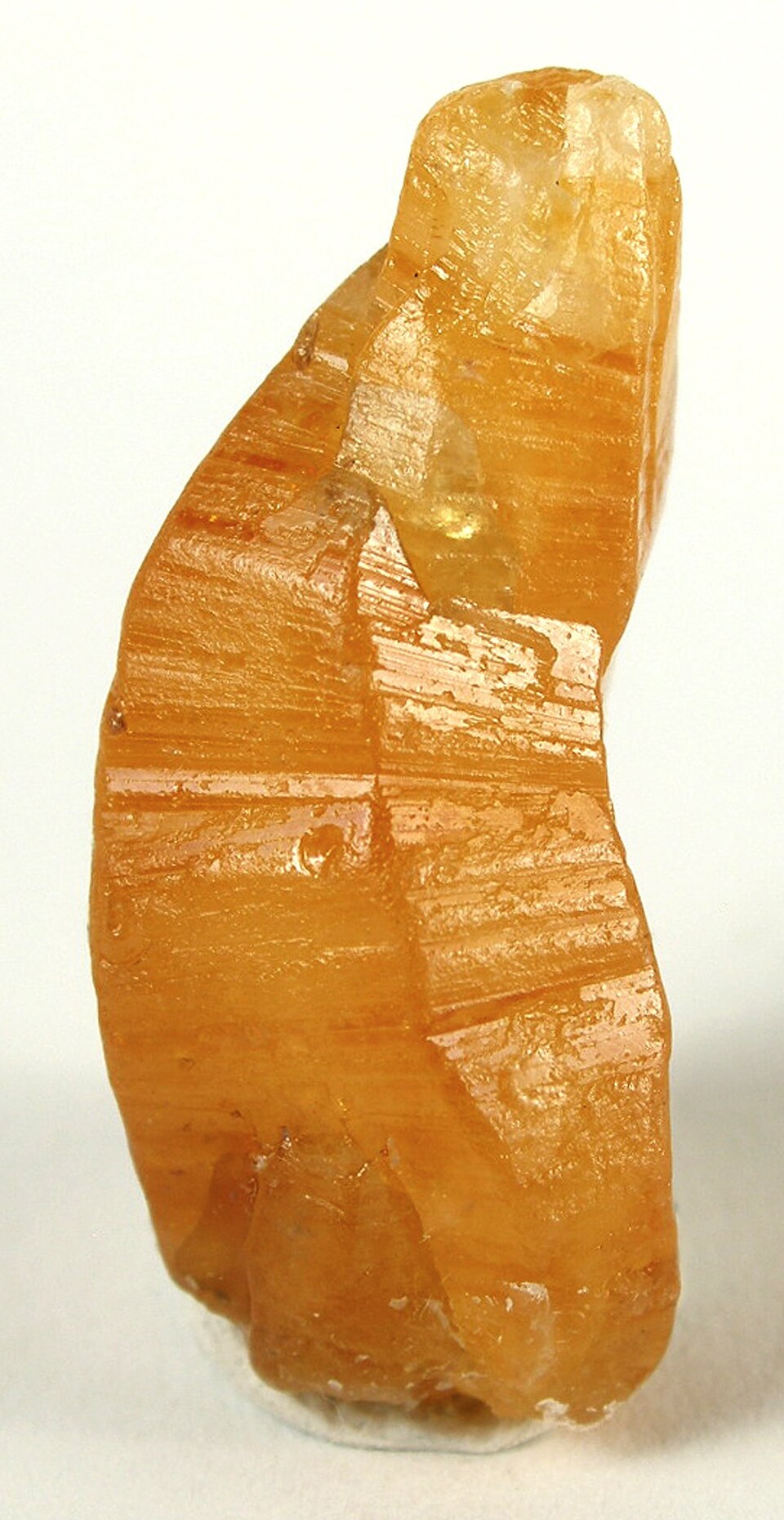 A yellow-orange sapphire-bearing corundum mineral specimen